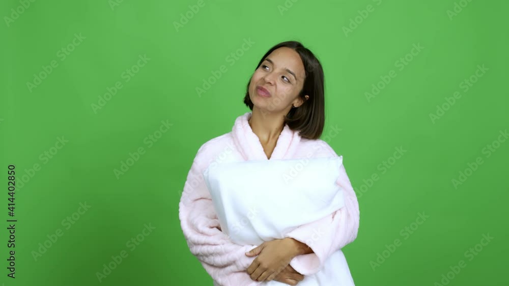 Woman in pajamas pointing a great idea and looking up over isolated background Woman in pajamas pointing a great idea and looking up over isolated background