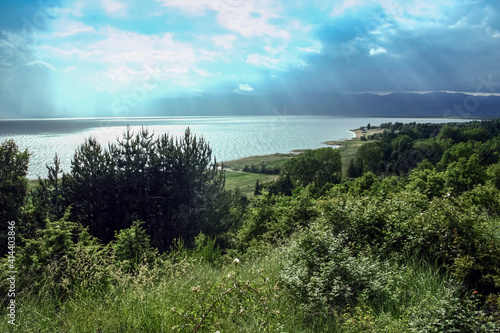 Panorama of the Prespa lake on North Macedonian side, after cloudy afternoon with mountains in background. Prespa, or Prespansko ezero, is a Balkans lake between Macedonia, Greece and Albania photo