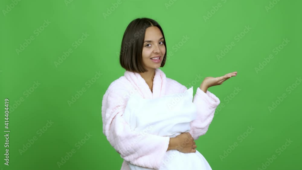 Woman in pajamas extending hands to the side and inviting to come over isolated background Woman in pajamas extending hands to the side and inviting to come over isolated background