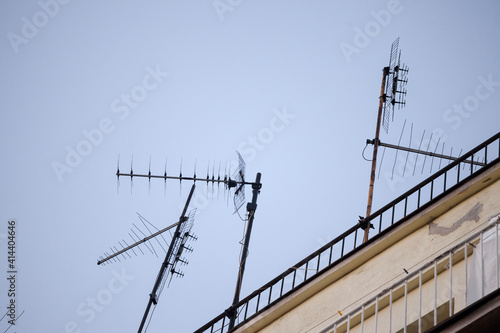 Television antennas, VHF and UHF frequencies, at the top of a European roof. VHF and UHF are two of the main TV transmission and reception systems