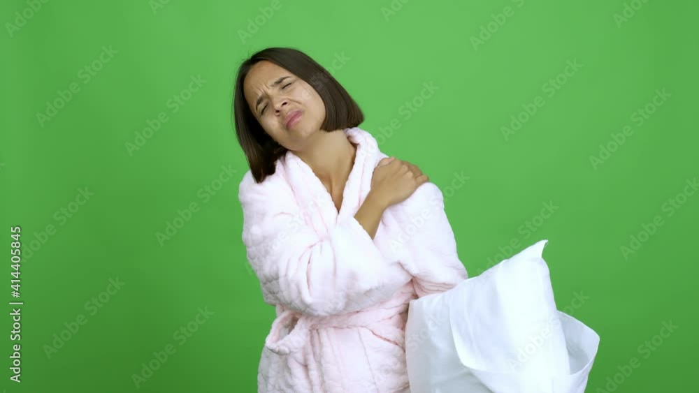 Woman in pajamas with shoulder pain over isolated background Woman in pajamas with shoulder pain over isolated background