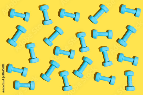 Fitness pattern in baby blue and trendy yellow. Fitness dumbbell concept on the minimal background.