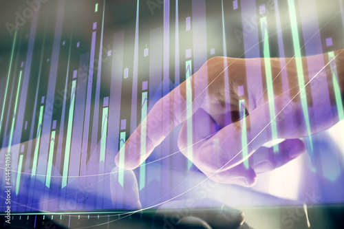 Multi exposure of man's hands holding and using a digital phone and forex graph drawing. Financial market concept.