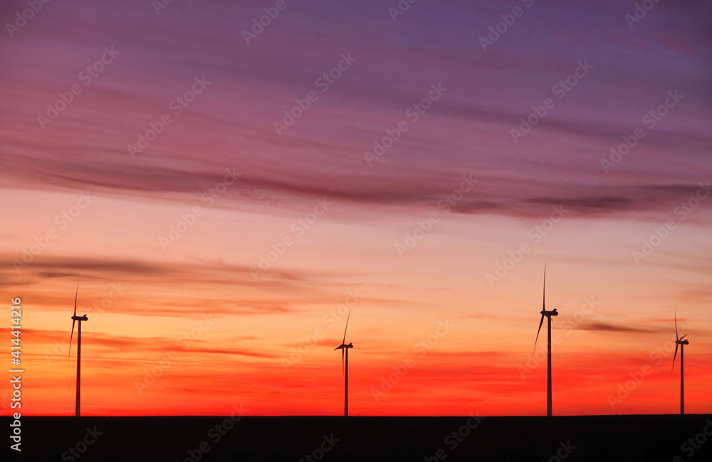 Wind turbines at sunset landscape