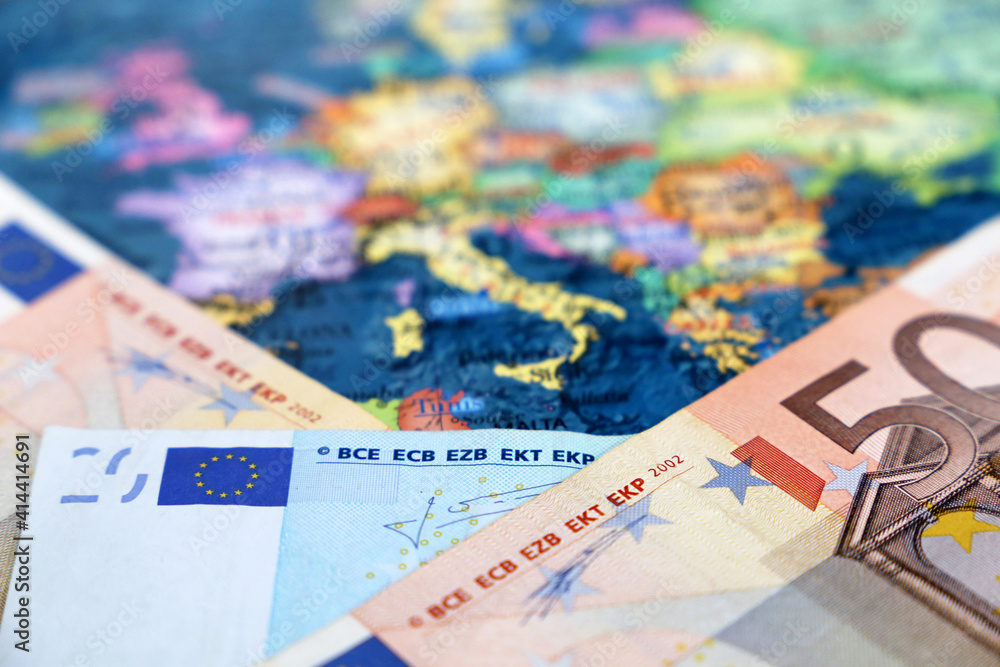 Euro banknotes on the Europe map. Concept of Eurozone, European economy, stock market in EU