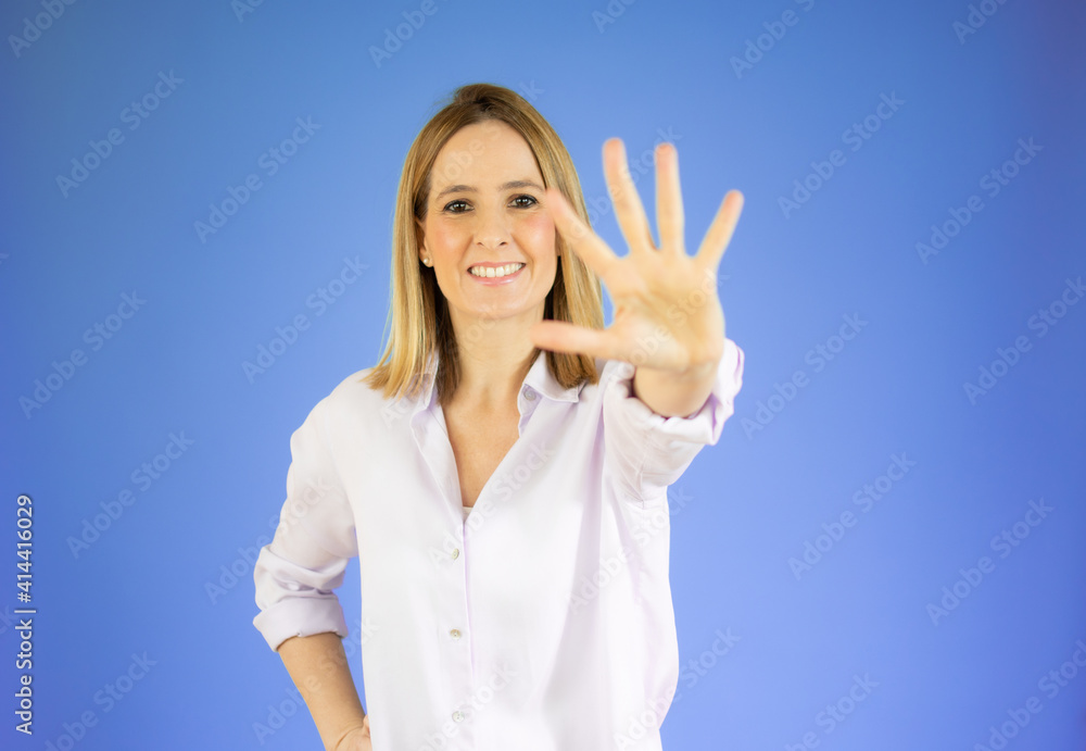 Young woman with blonde hair over isolated purple background counting five with fingers Young woman with blonde hair over isolated purple background counting five with fingers