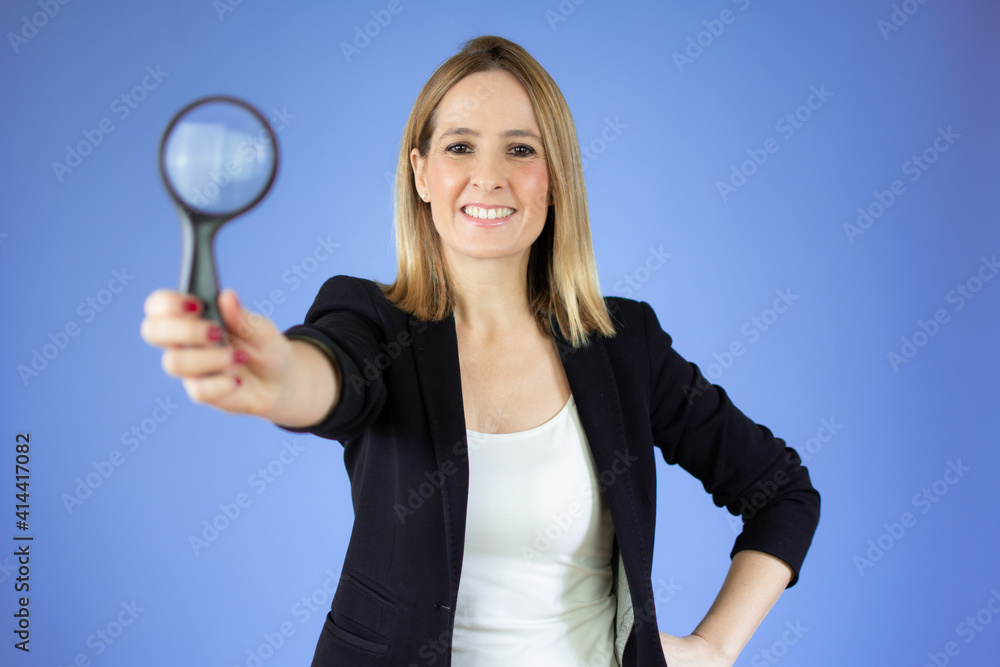 Woman with magnifying glass over purple background Woman with magnifying glass over purple background