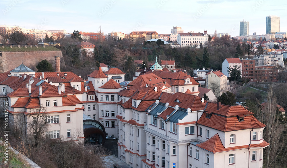 Aerial view of Prague, Czech Republic. Red tiled roofs of the houses with white walls from above view. Attic floor under the roof. Roof windows.