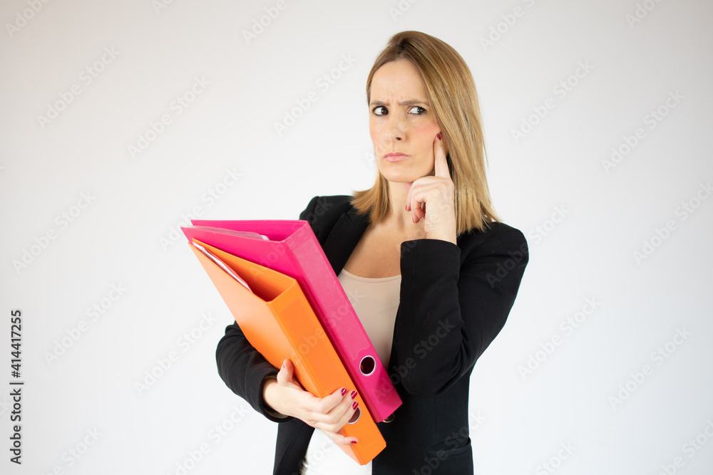 Portrait of young office woman seriously looking aside and holding finger at cheek isolated over white background Portrait of young office woman seriously looking aside and holding finger at cheek isolated over white background