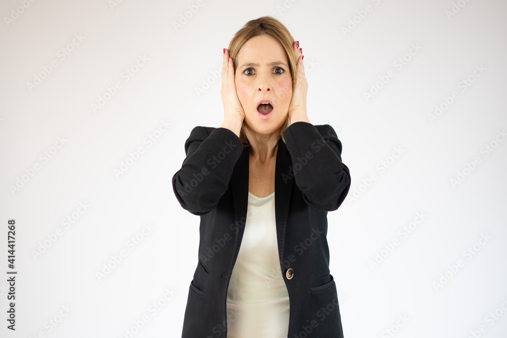 Frustrated and stressed young business woman in suit over white background. Frustrated and stressed young business woman in suit over white background.