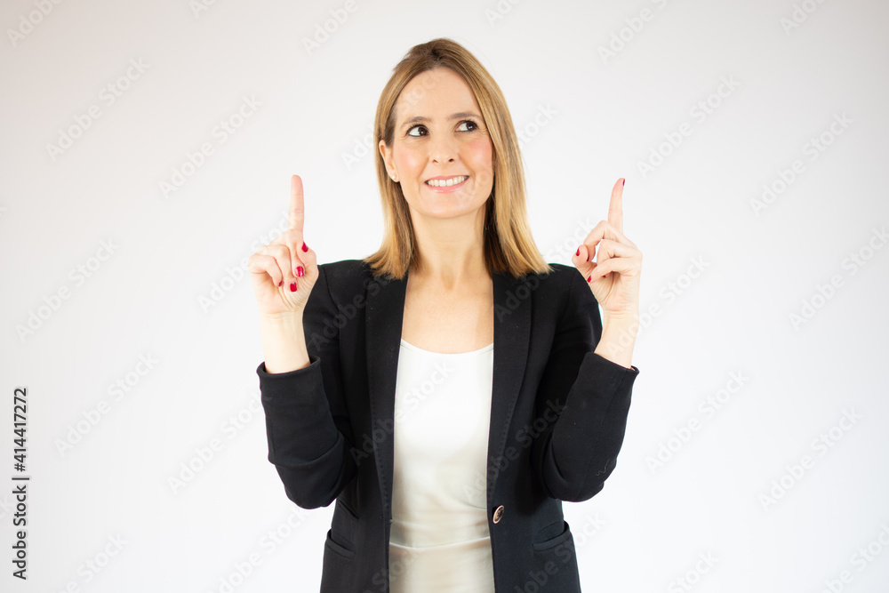 Portrait of beautiful young woman pointing up over purple background. Portrait of beautiful young woman pointing up over purple background.