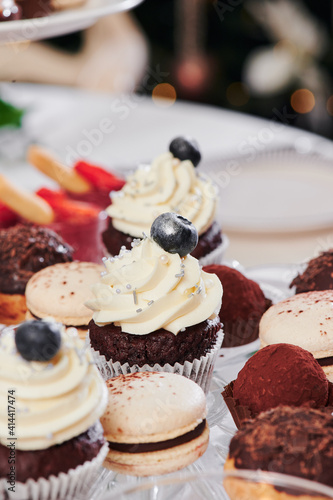 Sweet catering. Desserts and chocolate muffins on the festive table. Close-up
