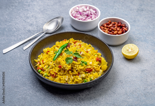 spicy Indian snack or breakfast poha with onion and peanuts