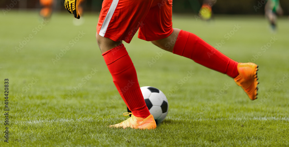 Obraz premium Football Goalkeeper Starts Game. Footballer Kicking Ball on Match. Goalie Kick Off