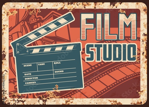 Film studio rusty metal plate with vector clapperboard, camera and filmstrip. Retro poster design for movie theater premier, cinematograph industry vintage rust tin sign, ferruginous promotion card