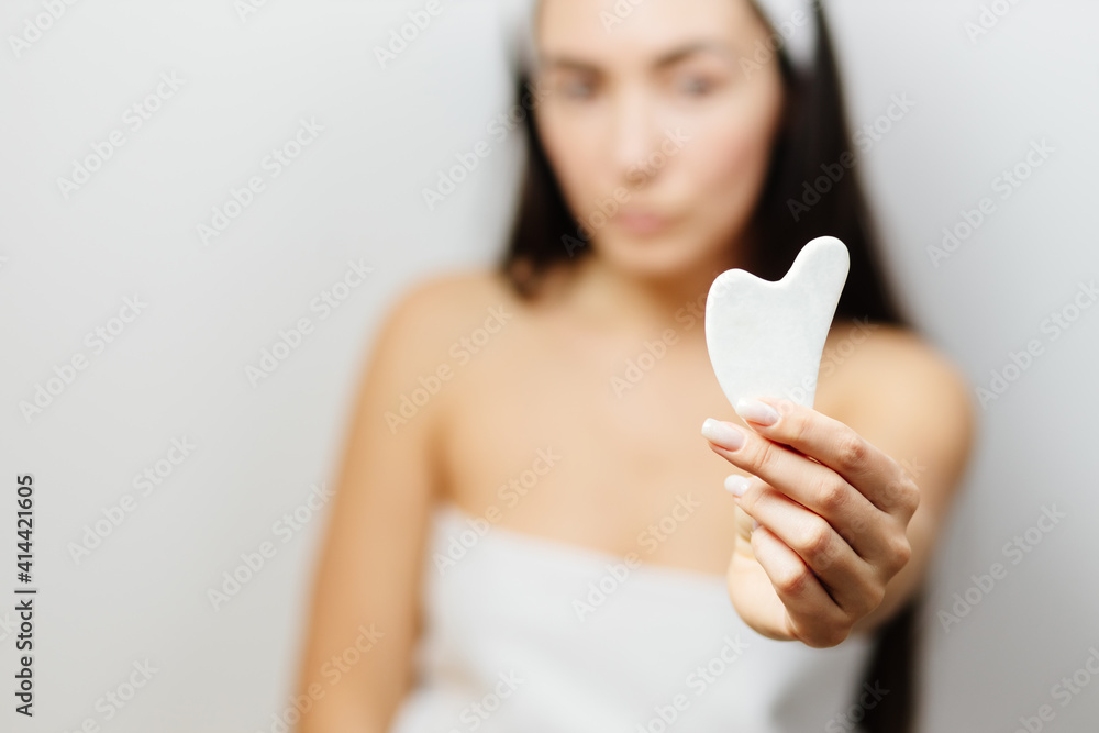 Woman using Gua Sha scraper over skin. Beautiful Caucasian Woman Using Gua Sha scraper over skin. beauty face skin care. Woman using Gua Sha scraper over skin. Beautiful Caucasian Woman Using Gua Sha scraper over skin. beauty face skin care.