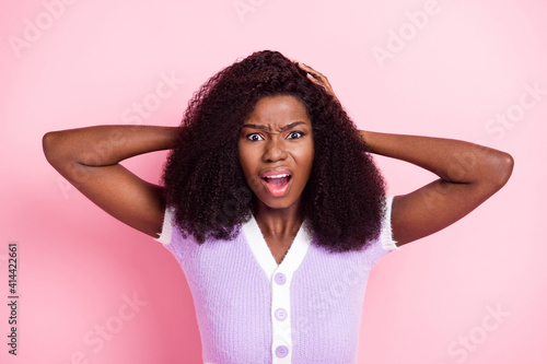 Portrait of attractive furious wild wavy-haired girl scolding bad reaction isolated over pink pastel color background