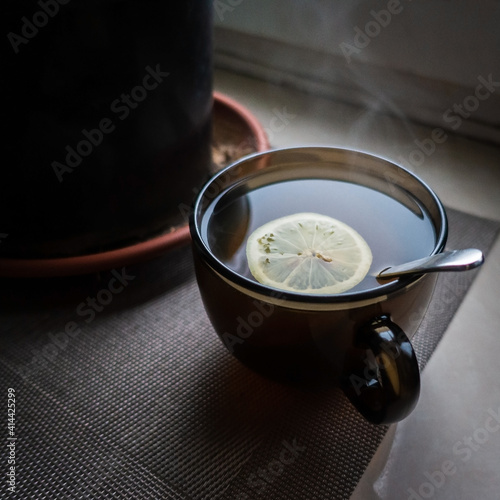 A cup of tea with lemon on the window on a Moscow winter day.