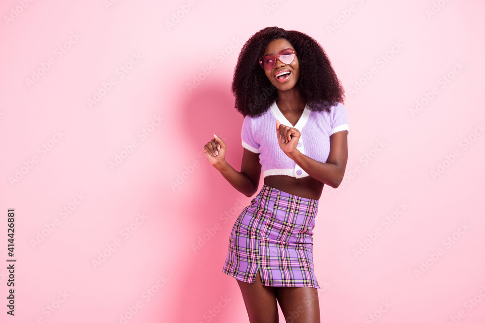 Portrait of pretty cheerful girl having fun dancing move weekend event isolated over pink pastel color background Portrait of pretty cheerful girl having fun dancing move weekend event isolated over pink pastel color background