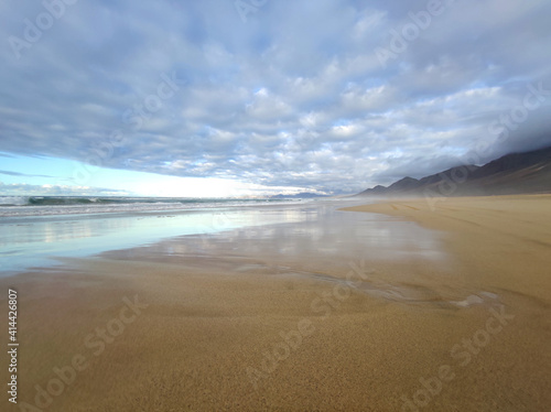 Cofete beach  amazing reflects and cloudy sky