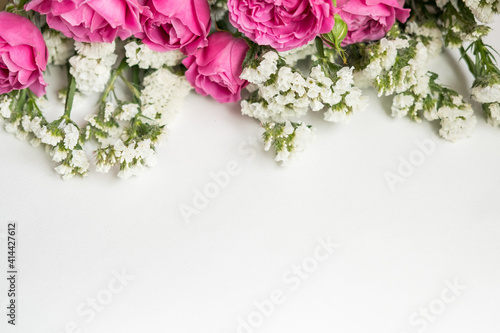 white dried flowers statice and rose raspberry peony on a white background . space for text