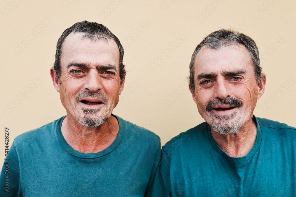 Fototapeta premium Senior twin men smiling on camera - Focus on faces