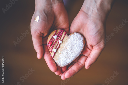 Woman in red shirt holds heart cake in hands,Symbol of love giving