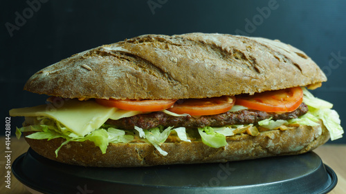 Big sandwich on dark background. sandwich with fresh vegetables