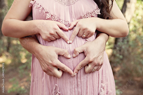 A pregnant couple with nice dresses