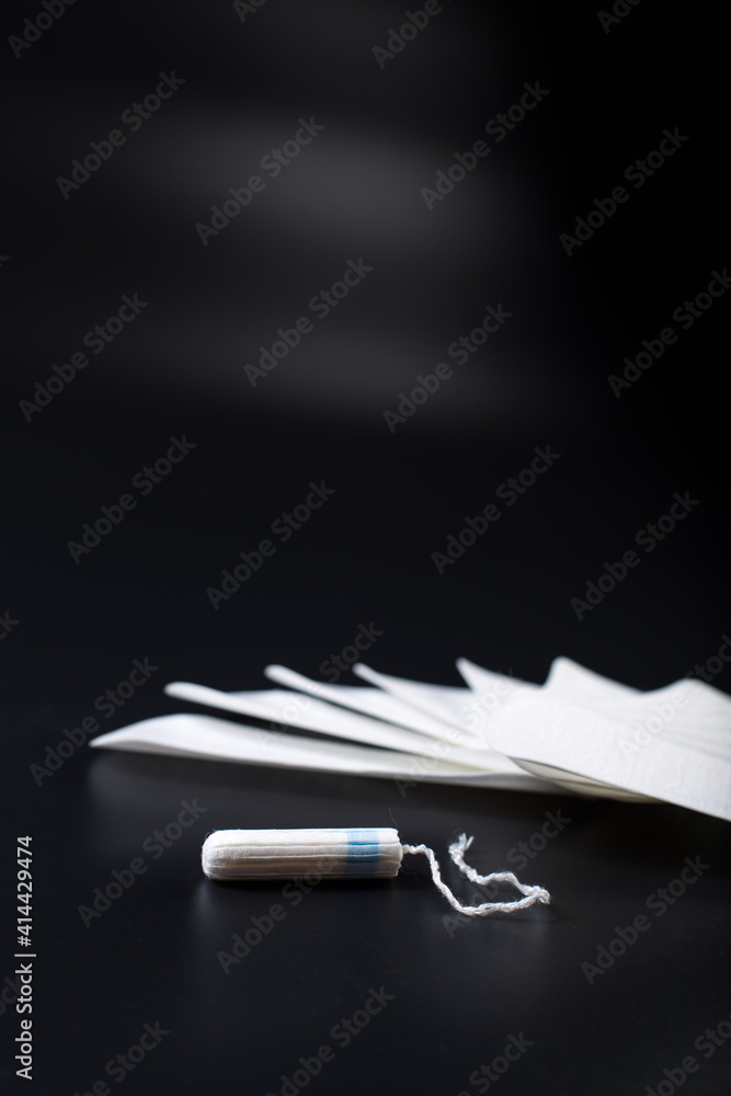 Tampon and panty liners on black background. Tampon and panty liners on black background.