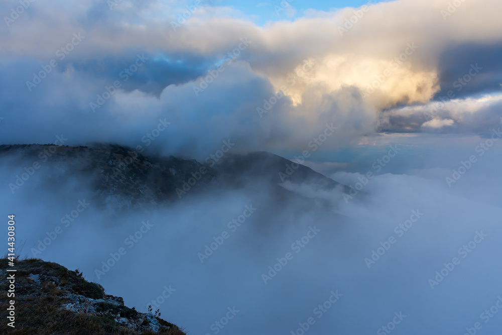 Atmospheric landscape with huge clouds over the mountain. Dramatic skies enveloped the mountains. Sad autumn landscape before the rain. Crimean nature reserve view from the gazebo of winds.