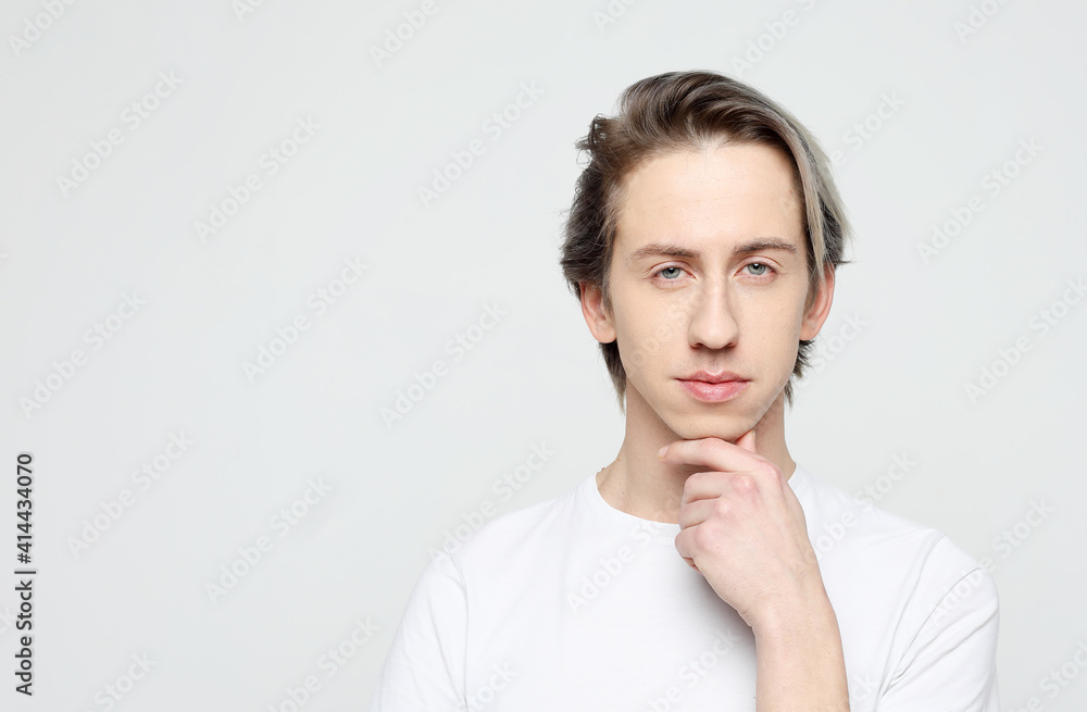 Lifestyle, emotion and people concept: handsome young man wear white t-shirt looking at camera Lifestyle, emotion and people concept: handsome young man wear white t-shirt looking at camera