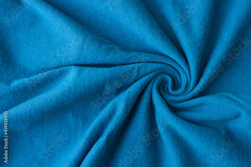 Blue fabric knitwear in a fold. Texture, background