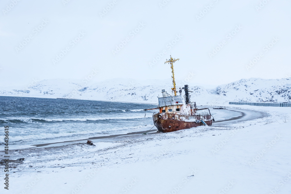 old rusty ship on the coast of the arctic ocean in winter. old rusty ship on the coast of the arctic ocean in winter.