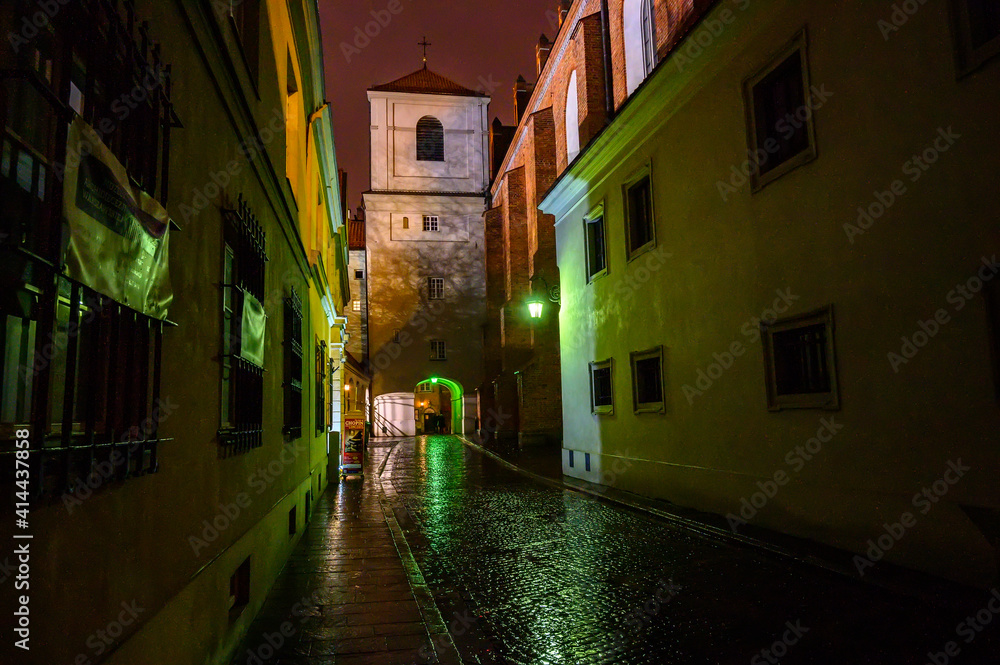 night old city narrow street in the town with colourful evening lights and pink sky 