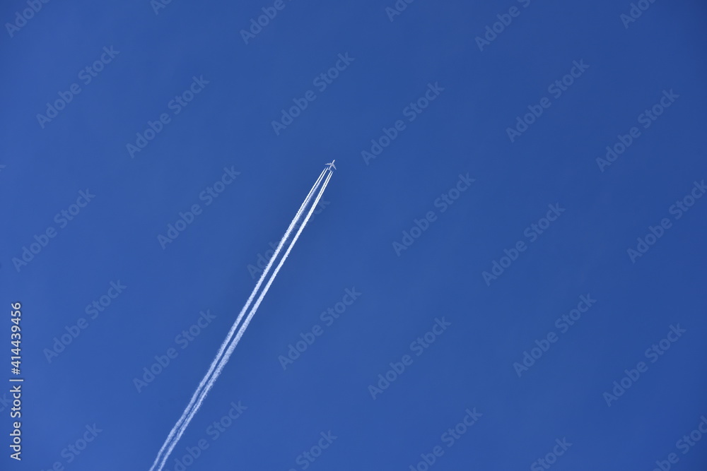 Blue sky with white airplane long contrail.Blue sky happy vacation time for freezing. large free area. Blue sky with white airplane long contrail.Blue sky happy vacation time for freezing. large free area.