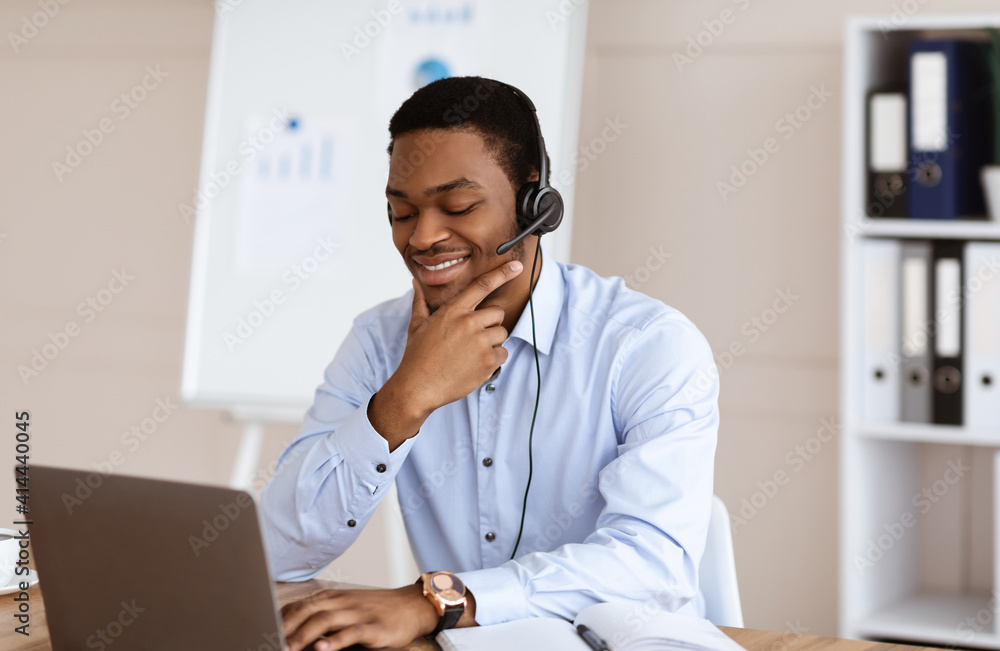 Positive young black man having business conference in office