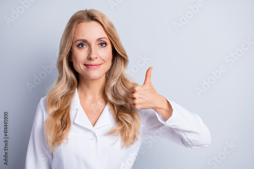 Wallpaper Mural Photo of mature beautiful lovely pretty smiling woman doctor showing thumb-up isolated on grey color background Torontodigital.ca