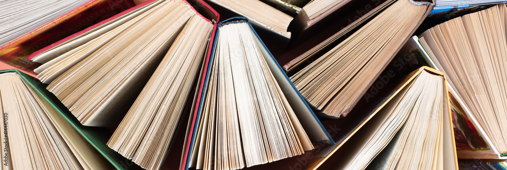 Fototapeta premium Many stacks of books. Old hardback books as background. Back to school