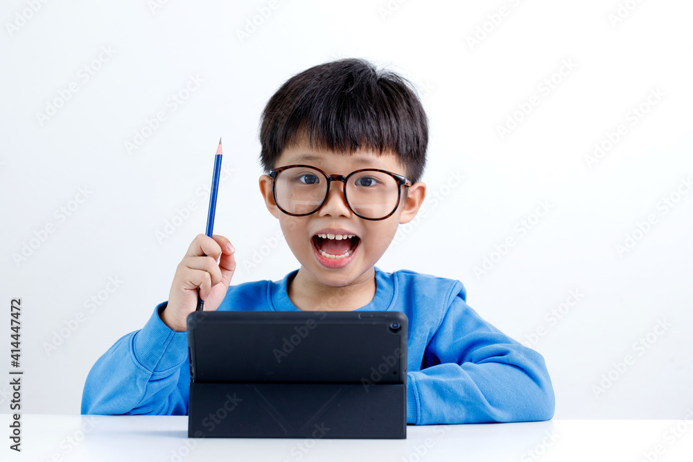 Smart little asian boy using tablet computer, isolated on white background. E-learning and education concept. Smart little asian boy using tablet computer, isolated on white background. E-learning and education concept.