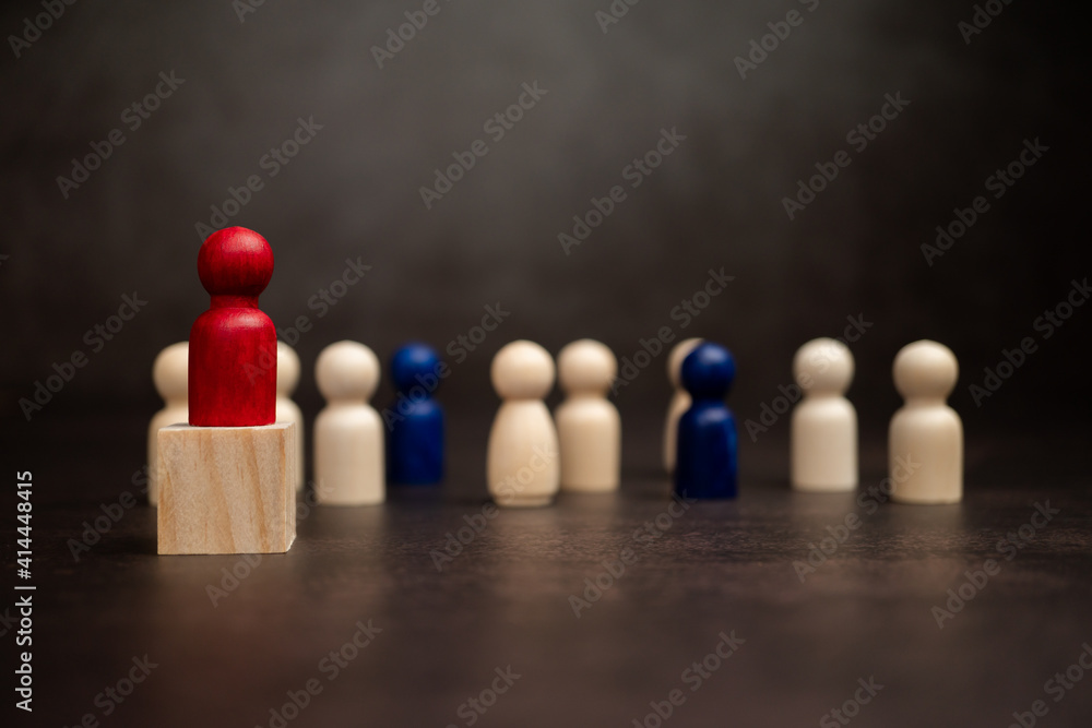 The leadership of the wooden figure standing on the box show influence and empowerment. Concept of business leadership for leader team, successful competition winner and Leader with strategy The leadership of the wooden figure standing on the box show influence and empowerment. Concept of business leadership for leader team, successful competition winner and Leader with strategy