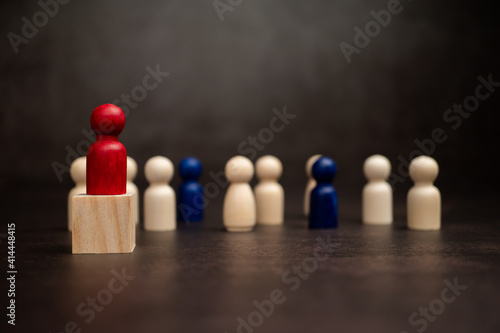 The leadership of the wooden figure standing on the box show influence and empowerment. Concept of business leadership for leader team  successful competition winner and Leader with strategy