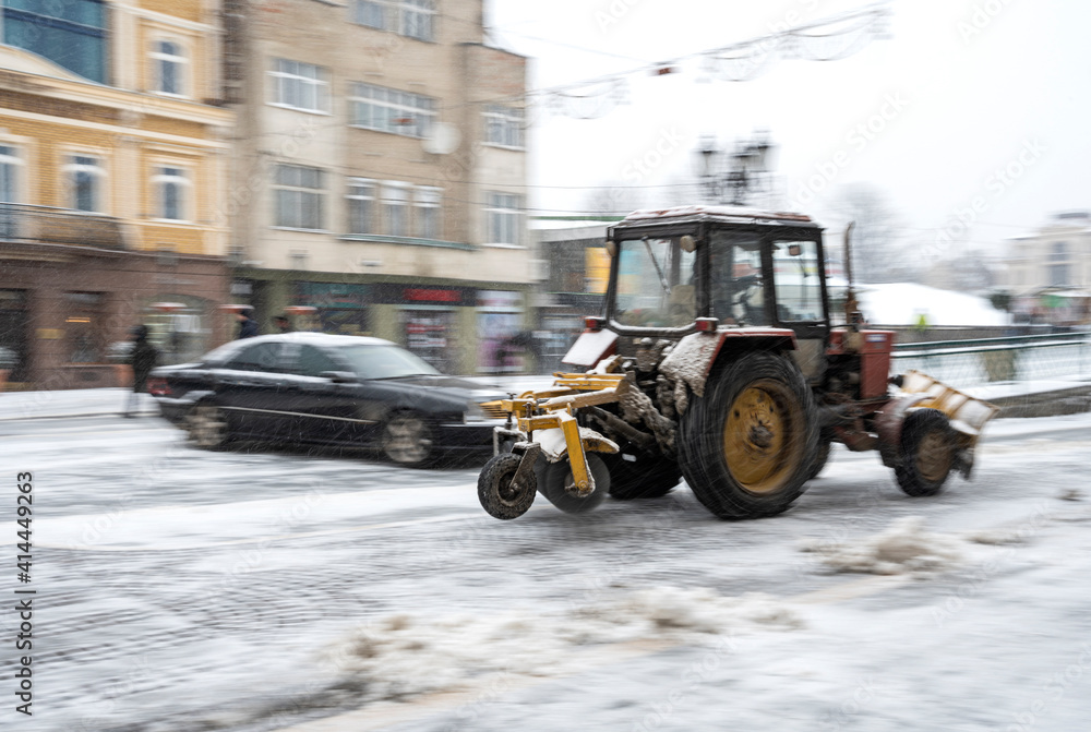 Snow removal machine cleaning the street from snow Snow removal machine cleaning the street from snow