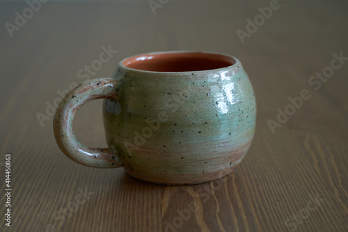 Pottery, a ceramic product with your own hands, made on a potter's wheel, a teapot, a mug.