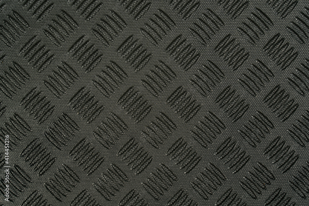 Closeup view stock photography of texture of black protective hdpe rug or mat for boot of automobile	