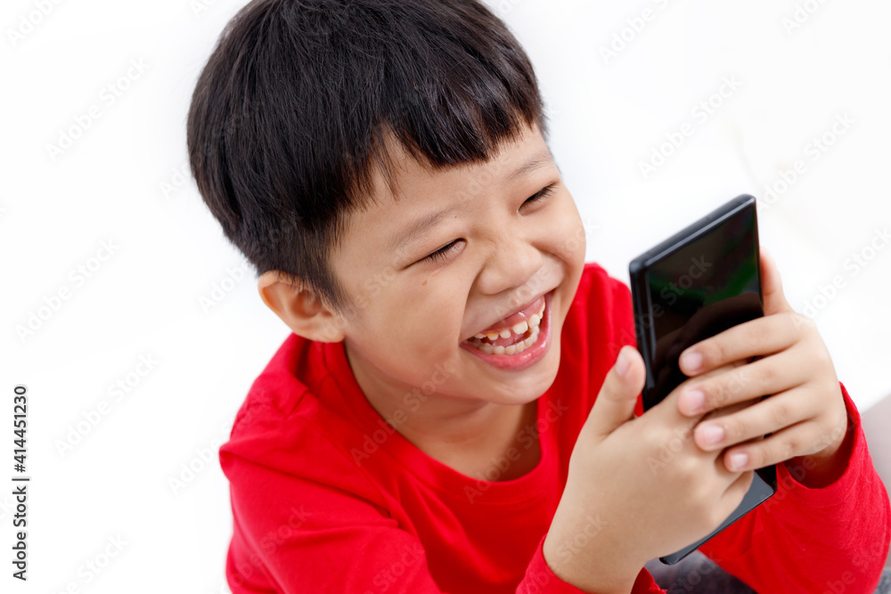Portrait of a happy little Asian boy having a video chat on a smartphone, isolated on white background. Portrait of a happy little Asian boy having a video chat on a smartphone, isolated on white background.