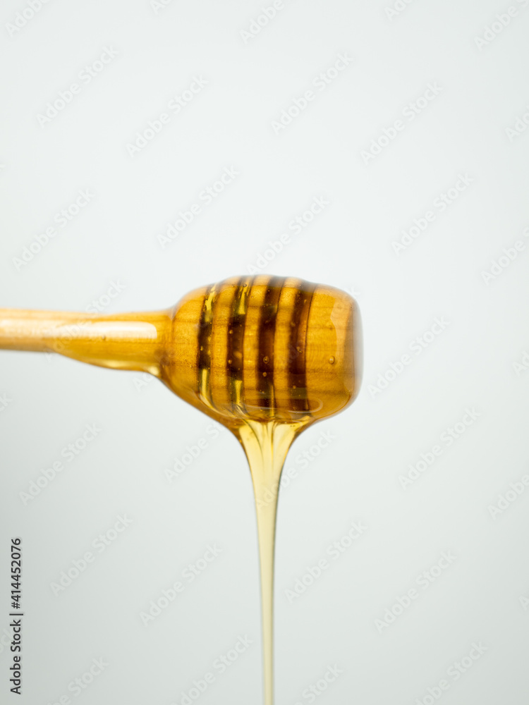Honey dripping from a wooden spoon Honey dripping from a wooden spoon