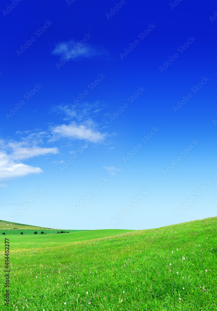 Idyllic view, green hills and blue sky with white clouds Idyllic view, green hills and blue sky with white clouds