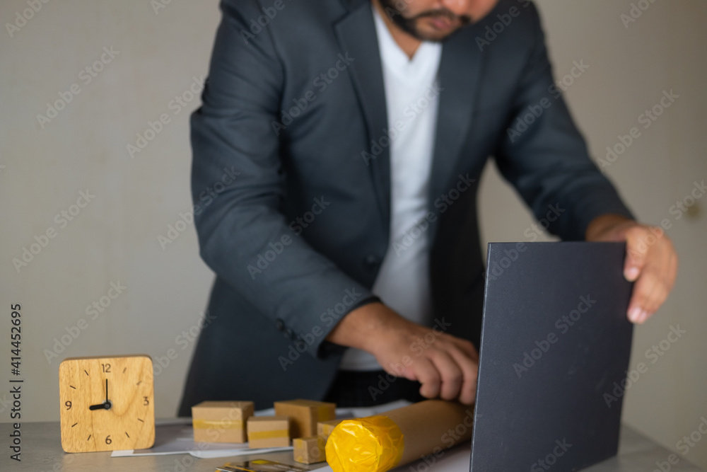 Engineer working of real estate project on office desk at workplace. Engineer working of real estate project on office desk at workplace.