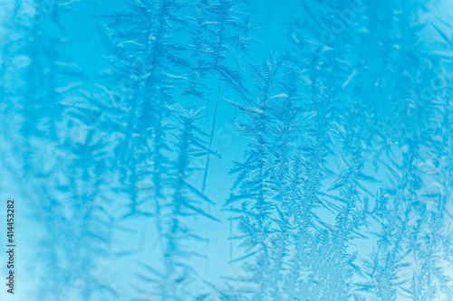 Ice patterns on frozen glass. Abstract ice pattern on winter glass as a background image. Copy  empty space for text